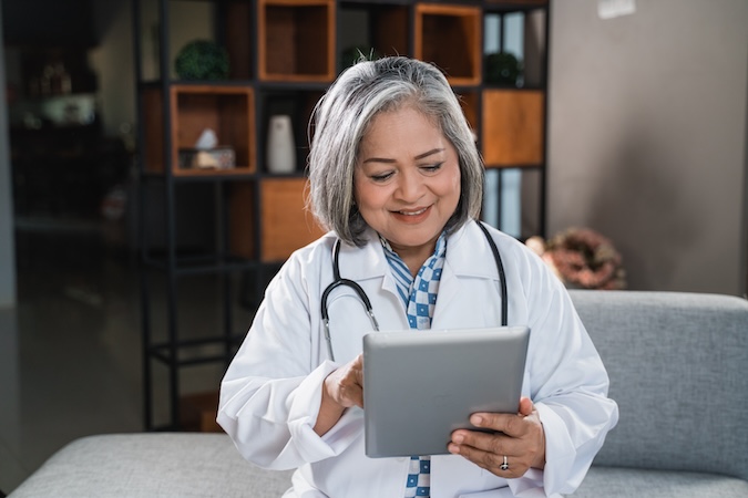 Doctor reviewing tablet in office